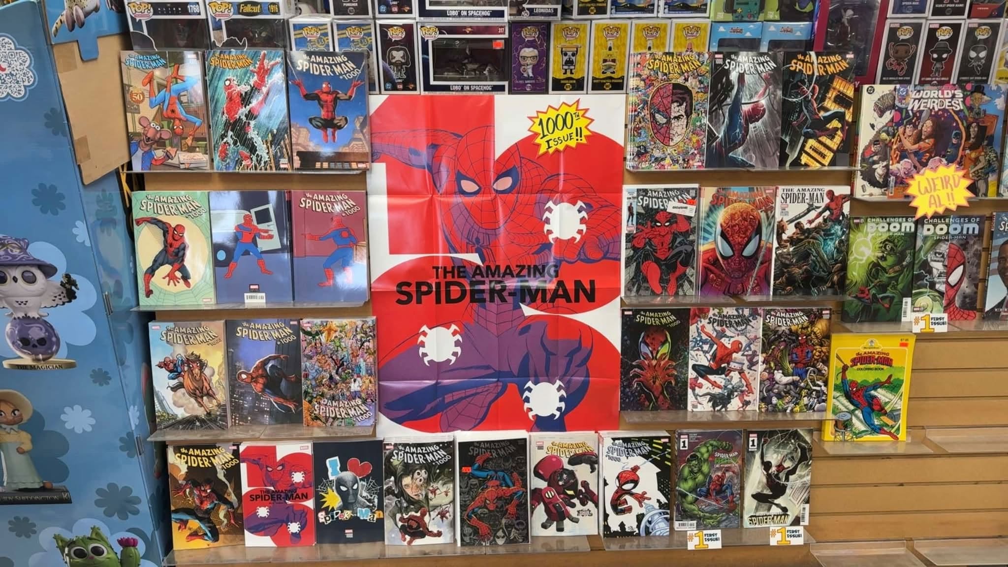 A wall of Amazing Spider-Man issue 1000 covers at The CORE, with collectible figures above